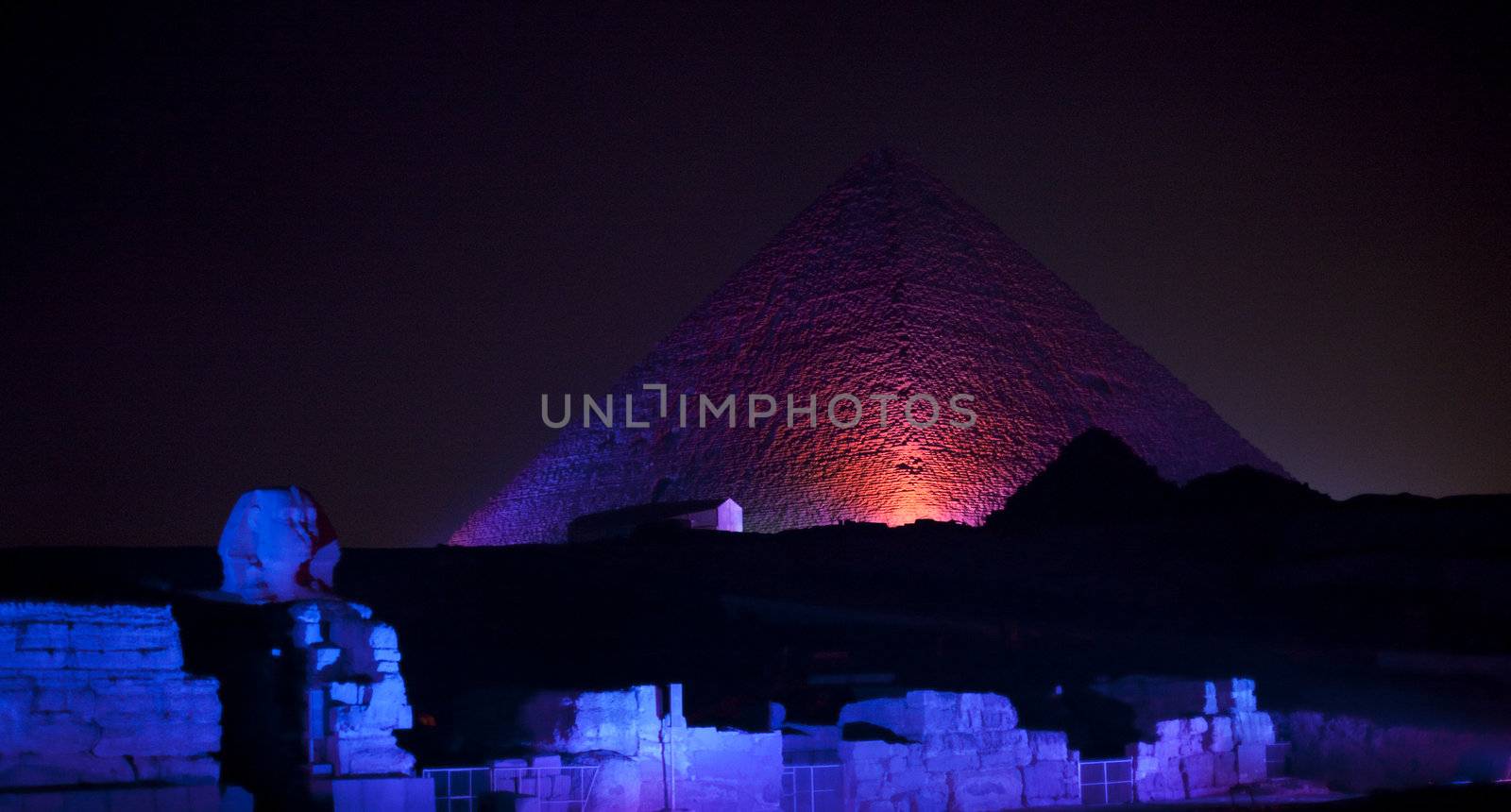 Colored lights illuminate Sphinx and Pyramids by steheap