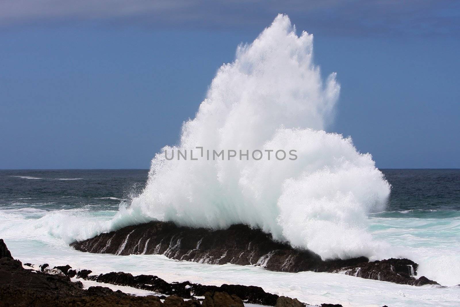 Wave exploding off rocks on the South African coast line