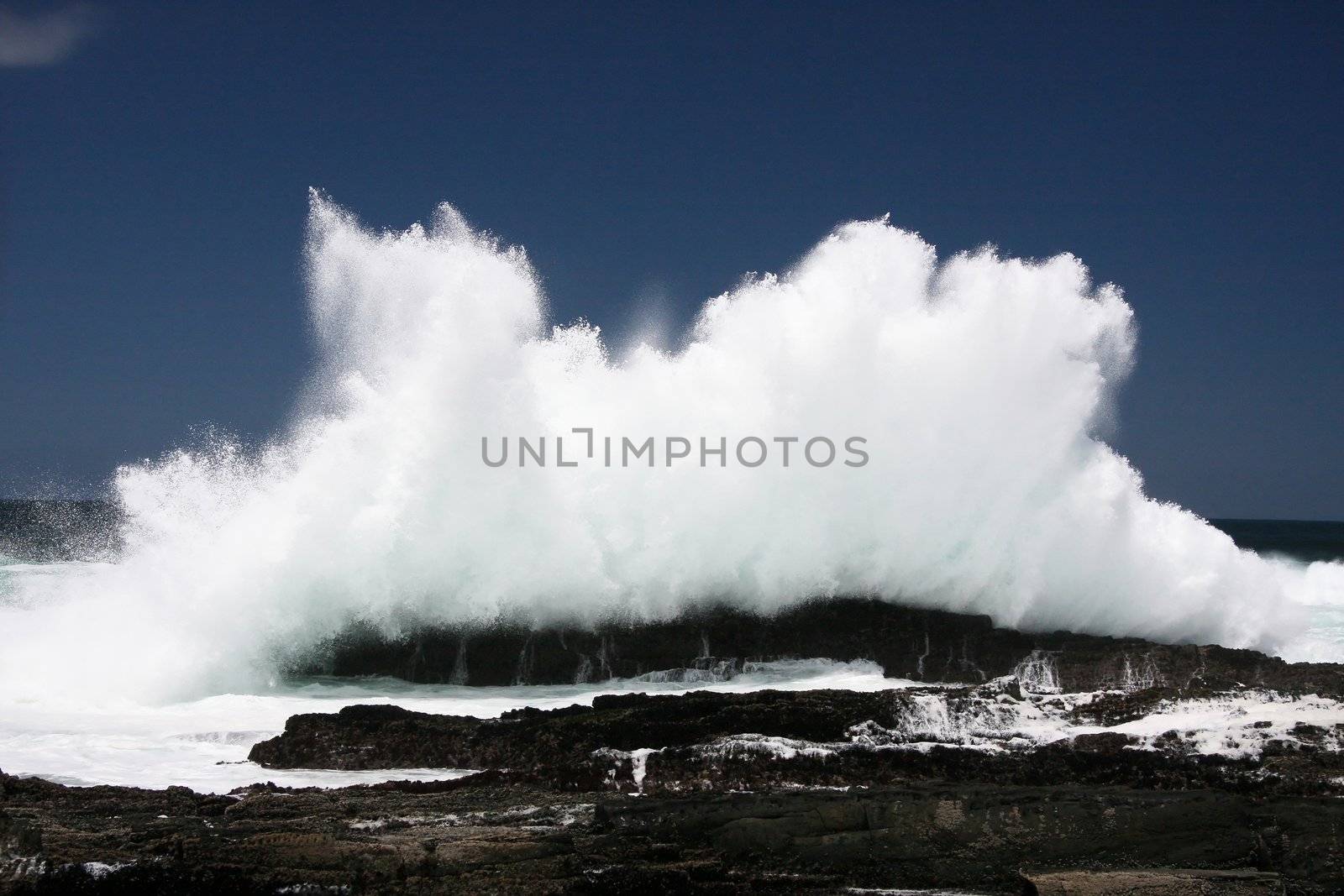 Wave exploding off rocks on the South African coast line