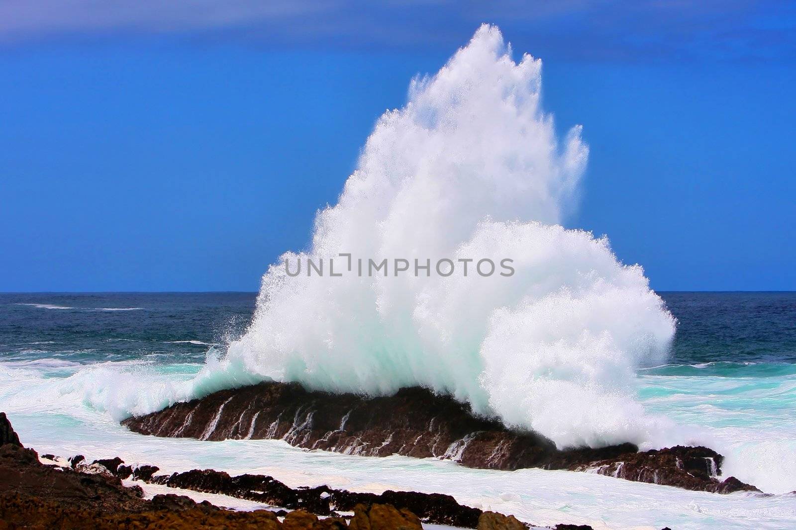 Wave exploding off rocks on the South African coast line