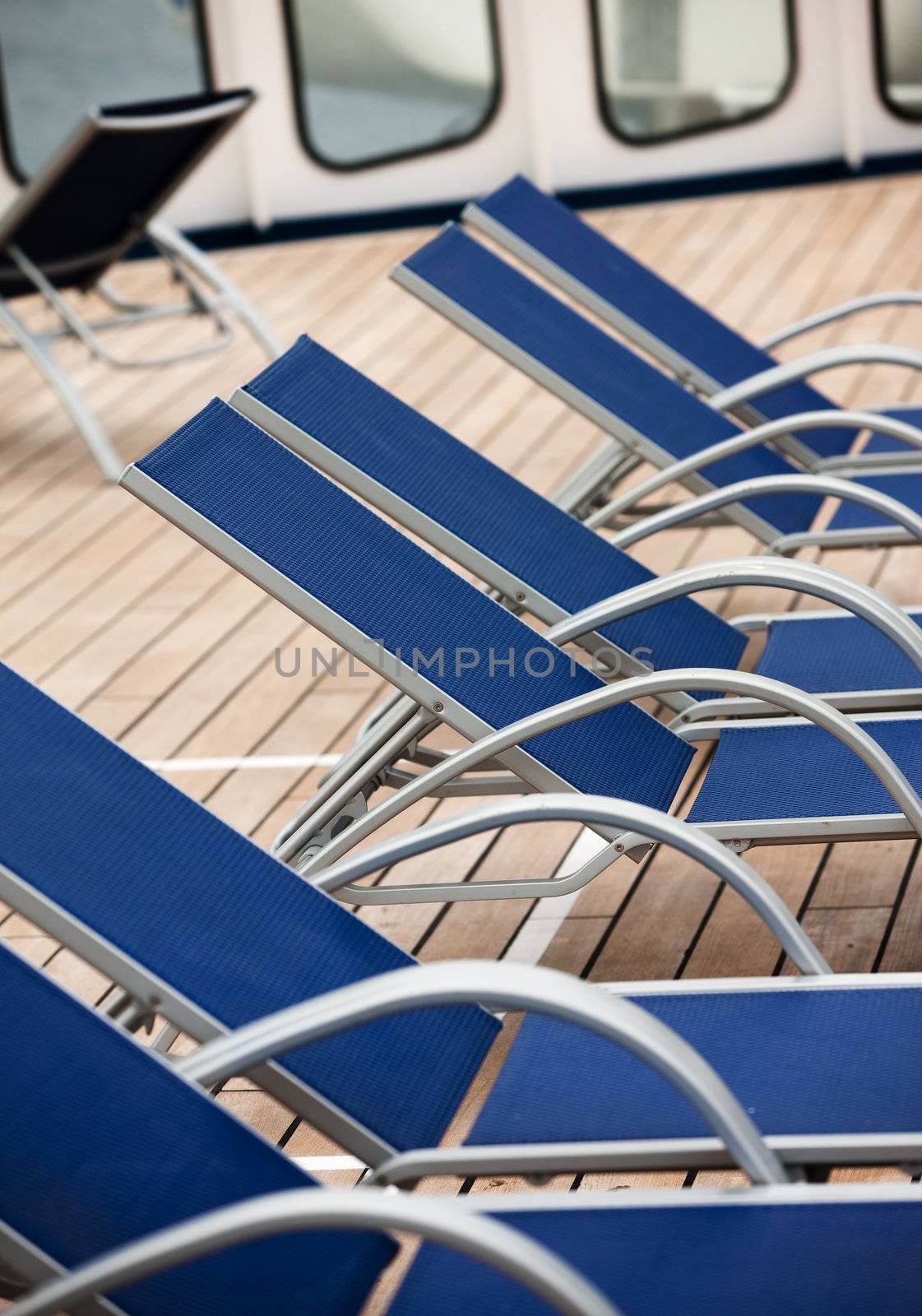 Empty deck chairs by Creatista