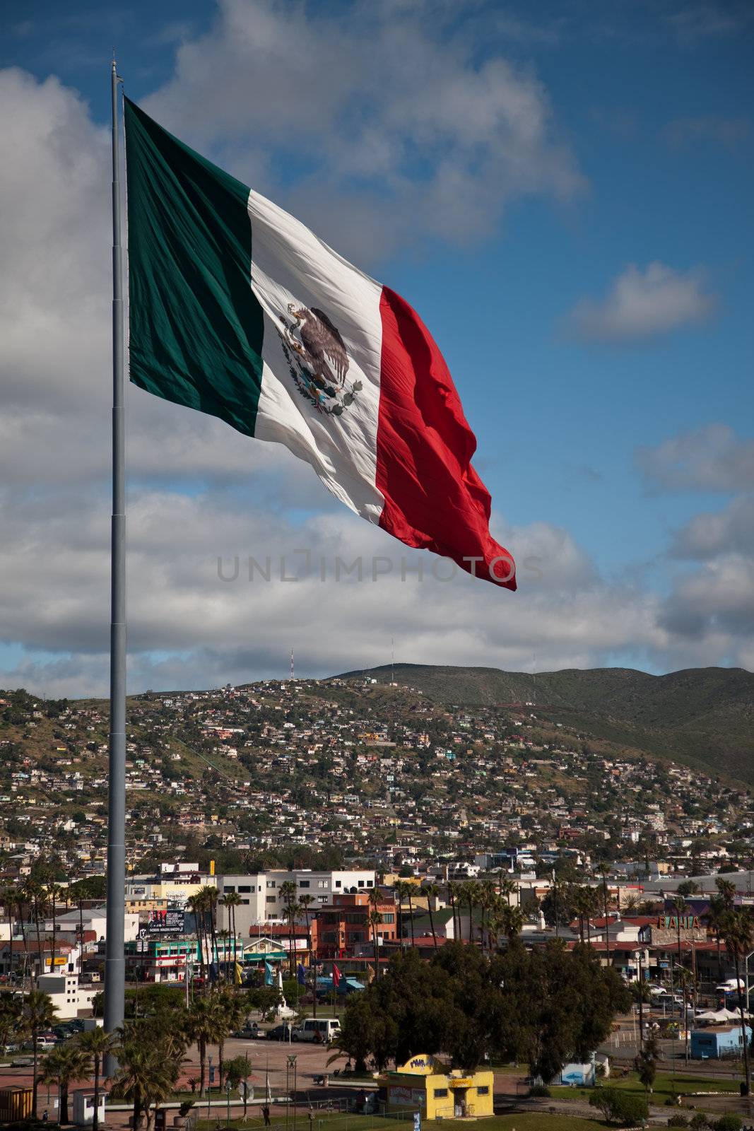 Large flag above Ensenada Mexico by Creatista