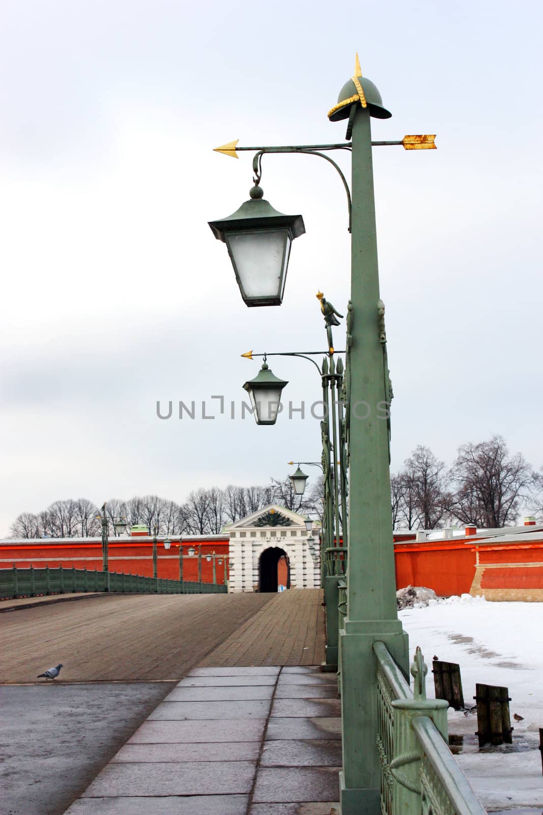 Peter and Paul Fortress, the bridge with lights, a fence on the bridge, dove, the entrance to krepos, the gate to the fortress, a symbol of Russia, a symbol of St. Petersburg