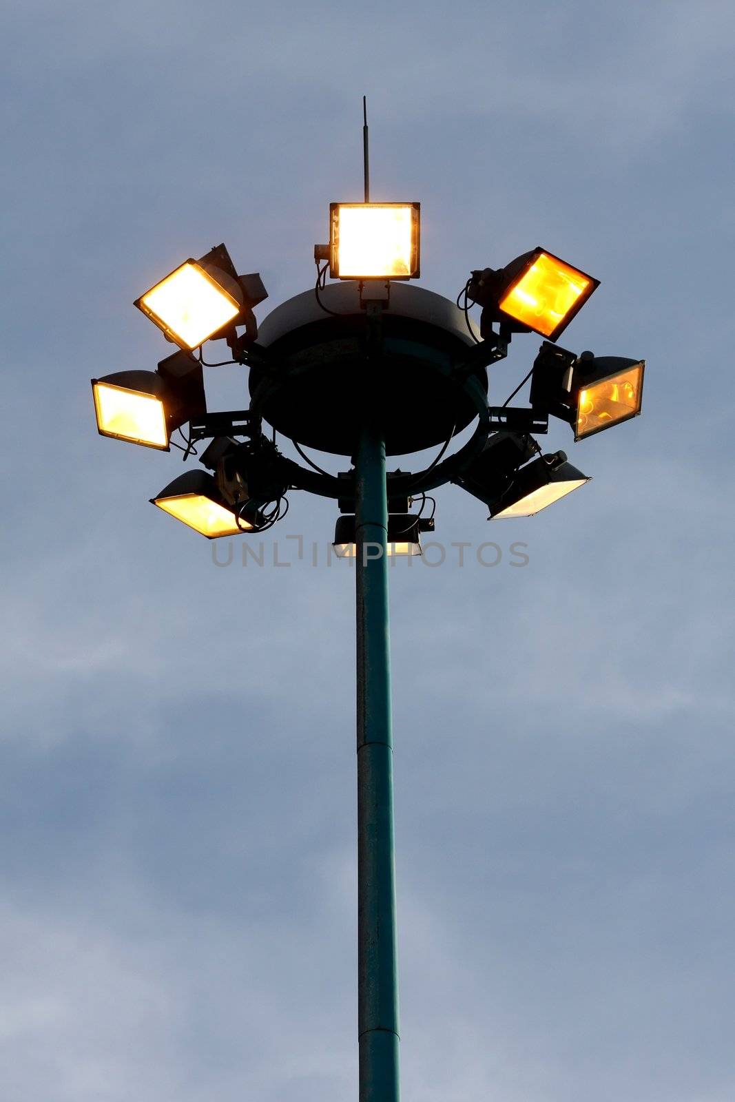 Security lights on top of a tall steel mast