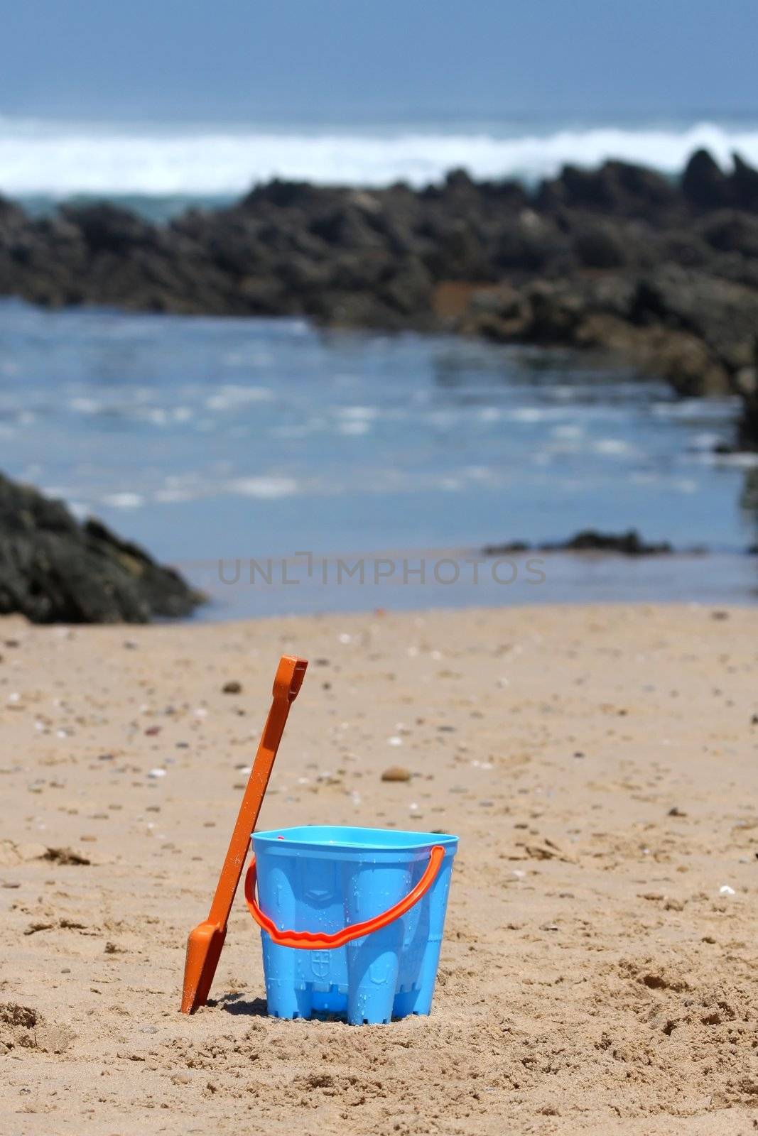 Children's bucket and spade on a sandy beach