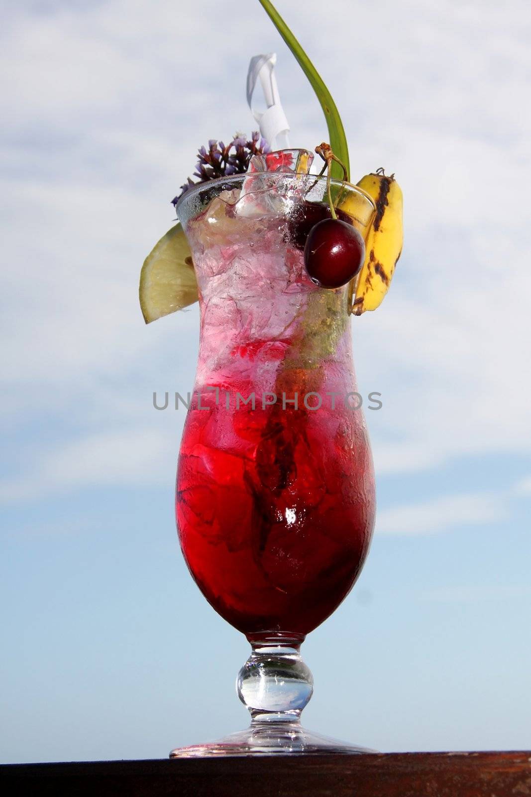 Tropical cocktail drink in a tall glass with lots of ice