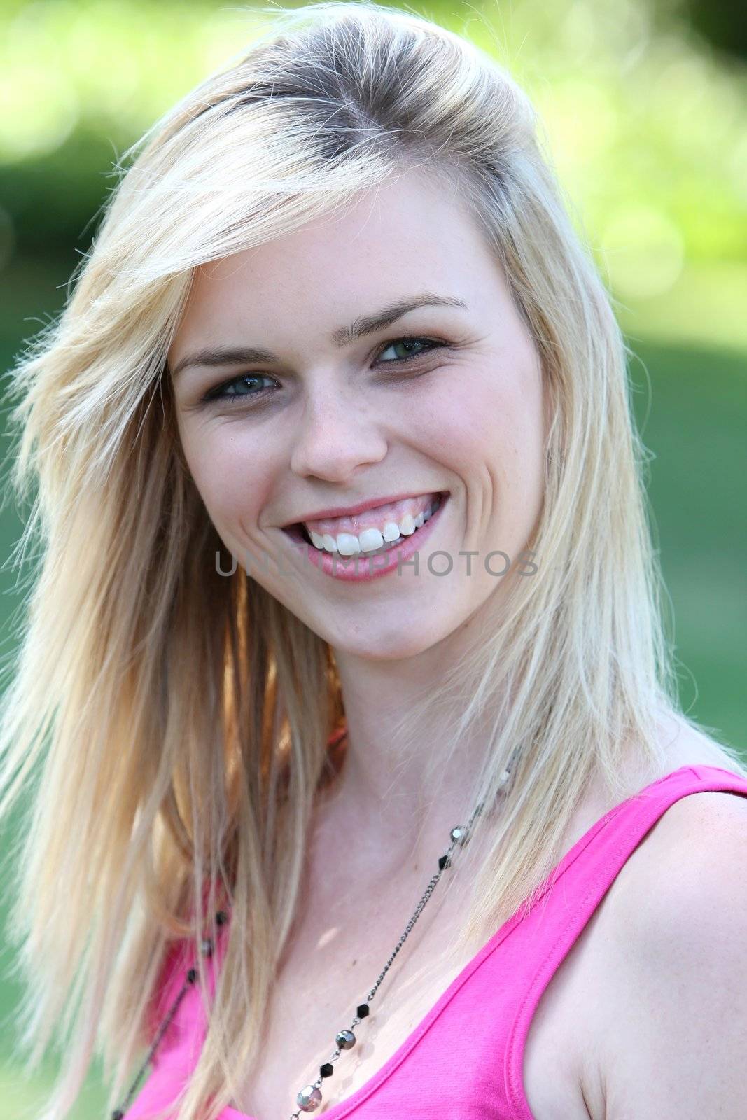 Portrait of a lovely blond lady with a big smile