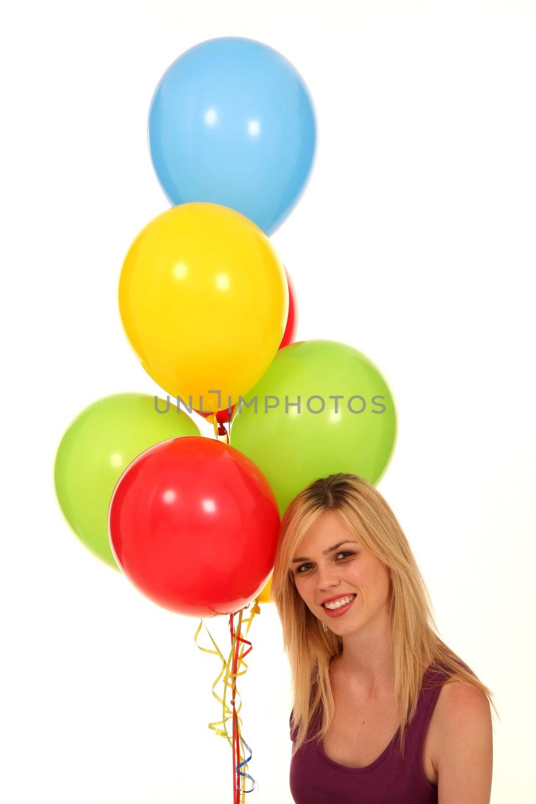 Beautiful blond girl holding a colorful bunch of balloons