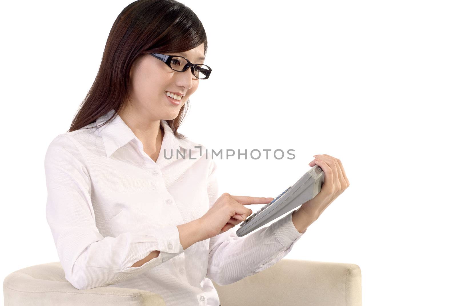 Business woman calculating and smiling and sitting on sofa against white background.