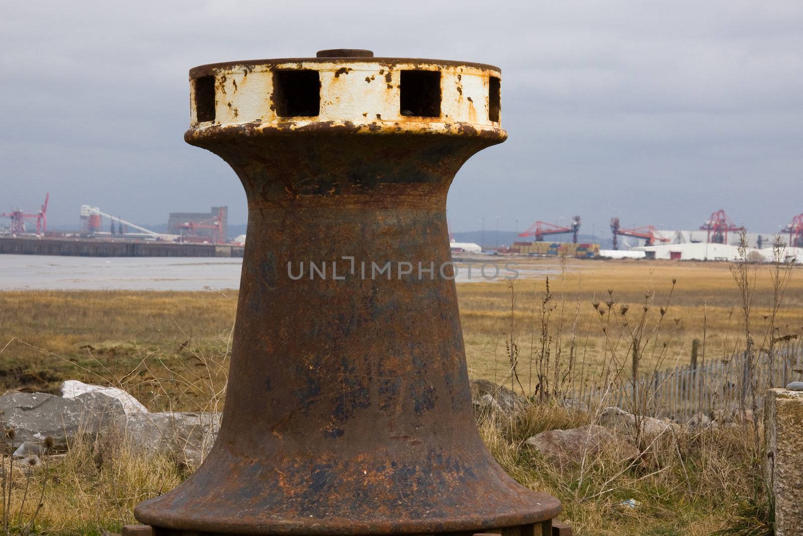 Capstan on old quayside at Portishead with Avonmouth docks on the horizon
