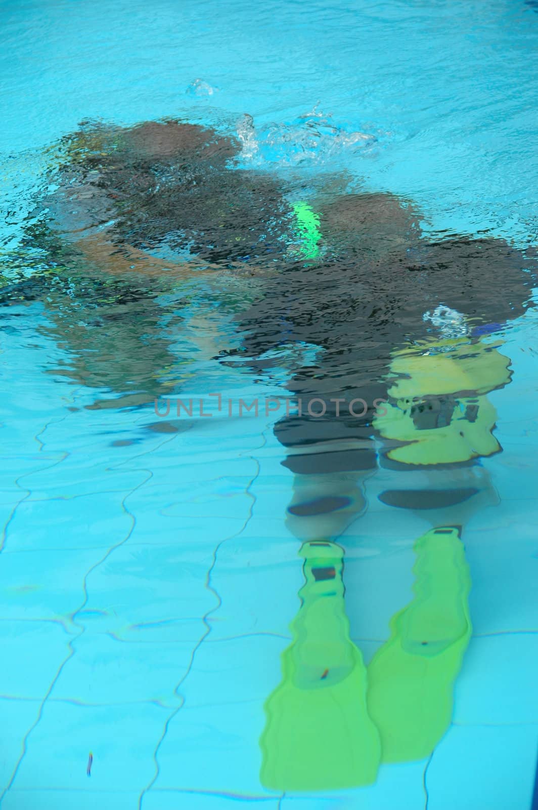 A instructor is traning a student how to dive