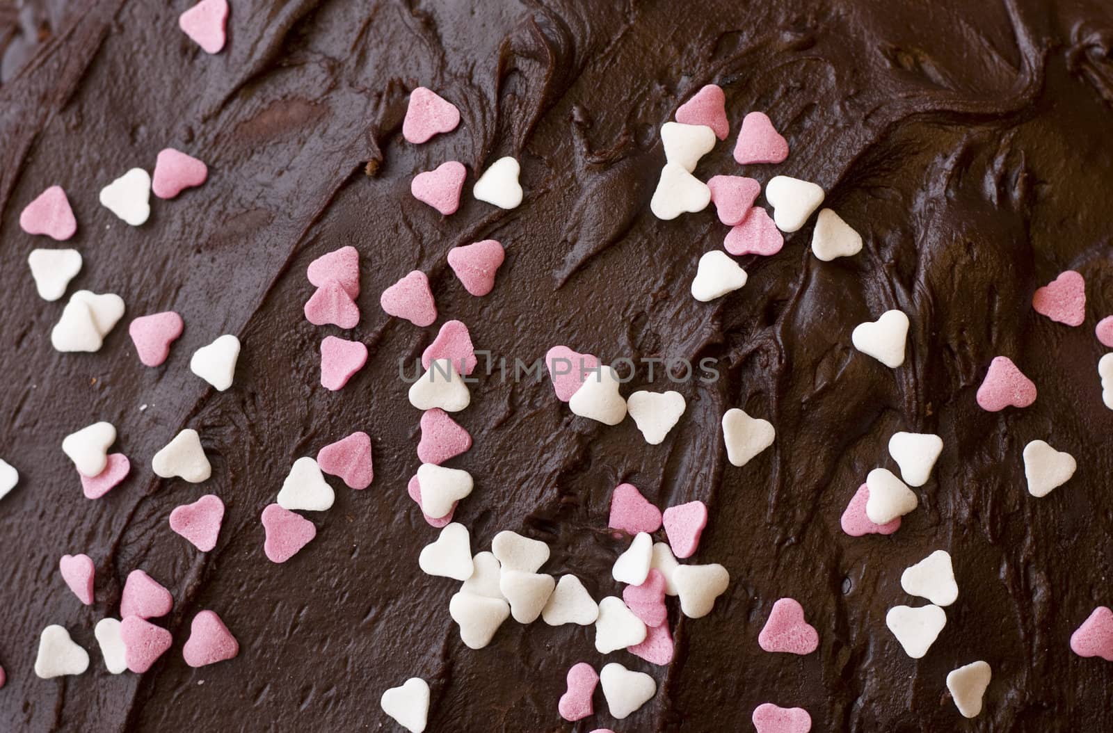 Chocolate frosting with pink and white hearts