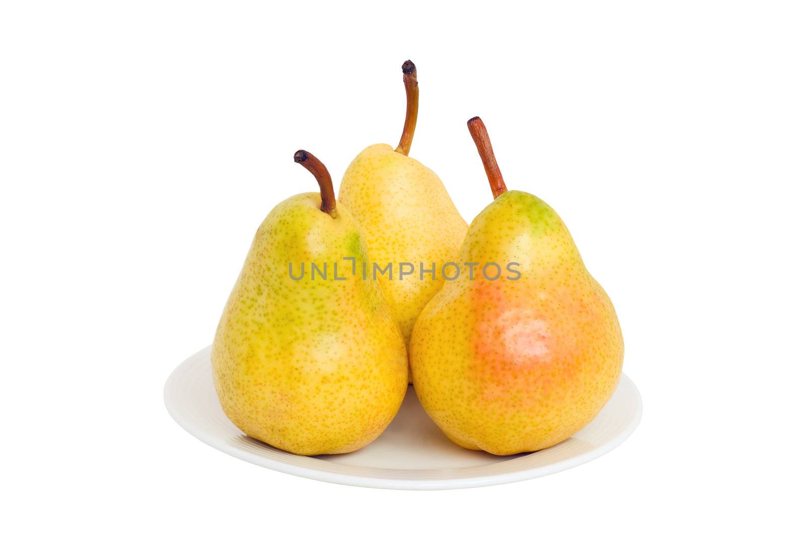 Three pears lie on a plate isolated on a white background.