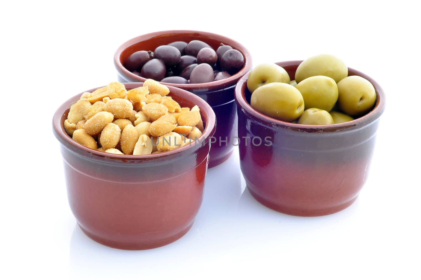 containers with olives and peanuts on a white background