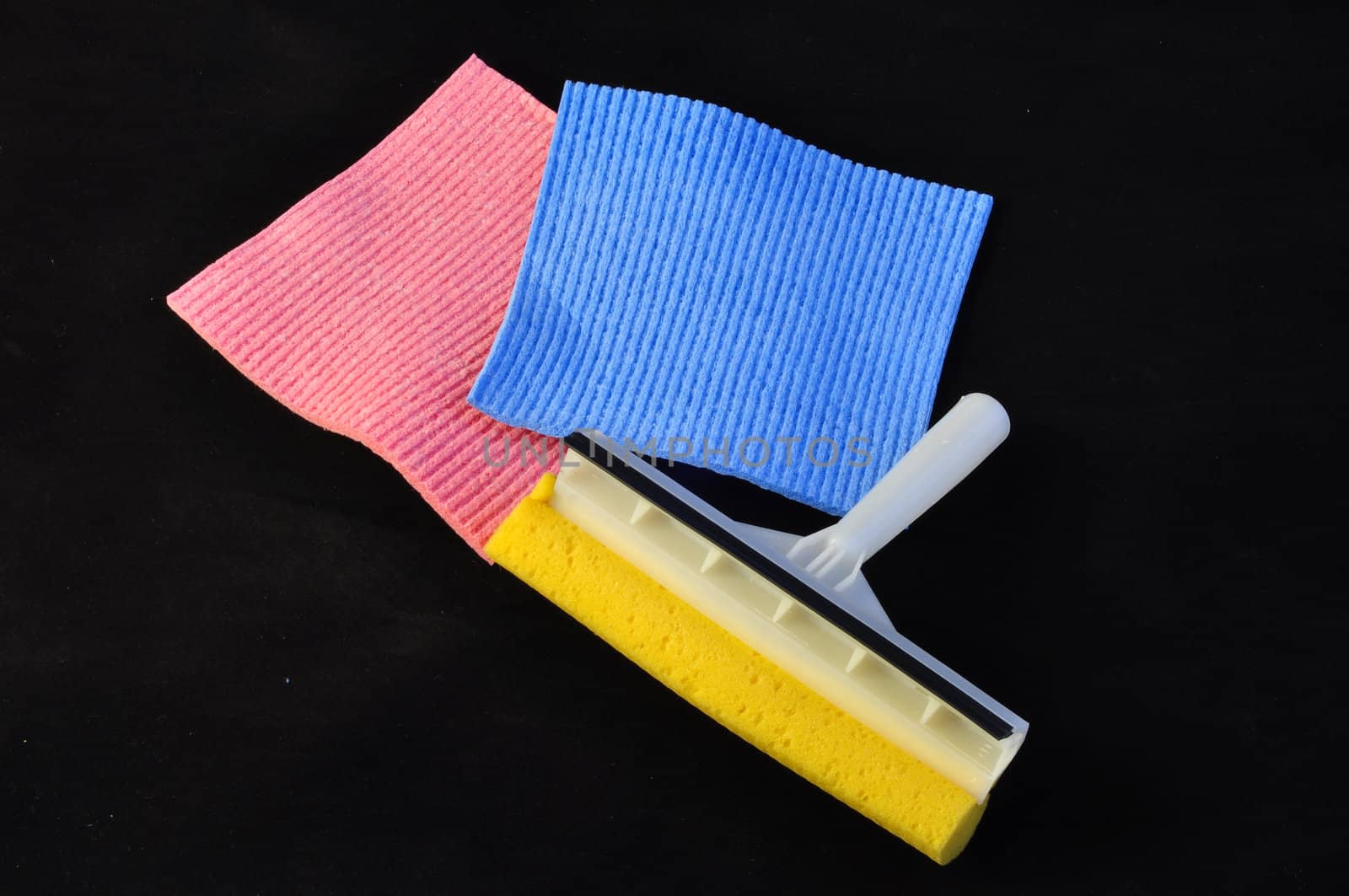 Colorful sponges and washer white and yellow on black background