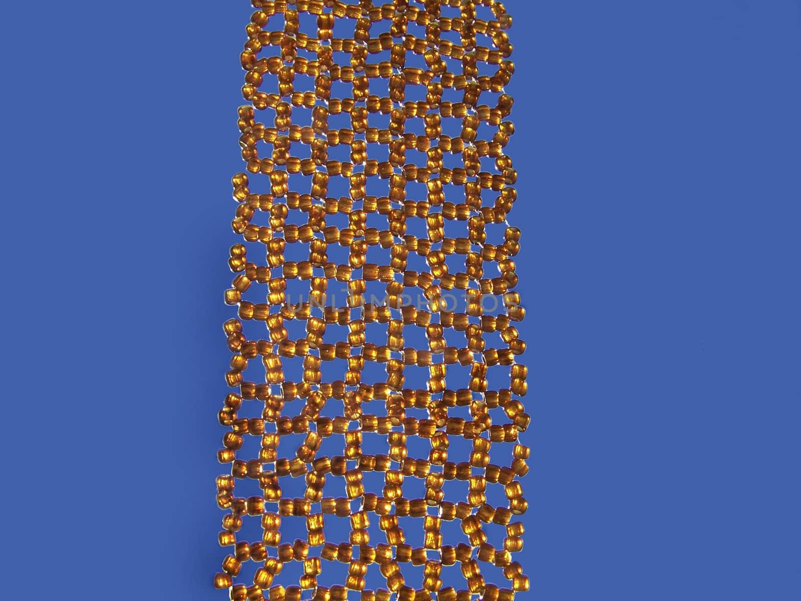 Close up of brown beads at blue background.