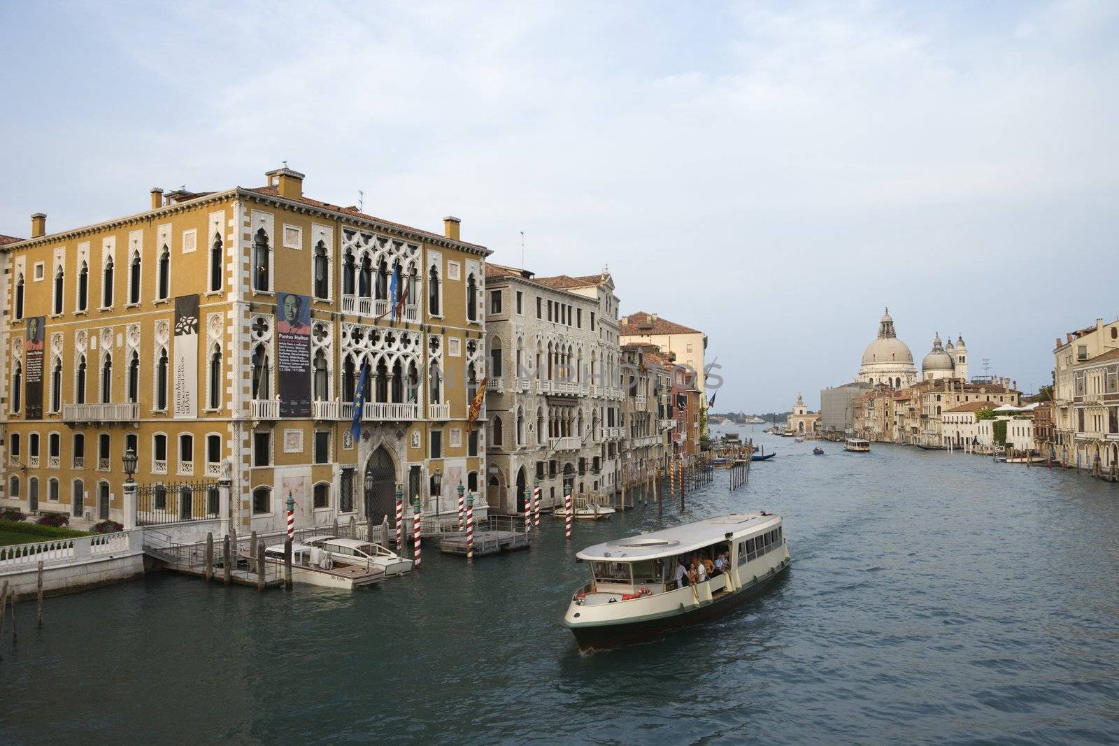 Buildings and cruise boat on canal in Venice, Italy.