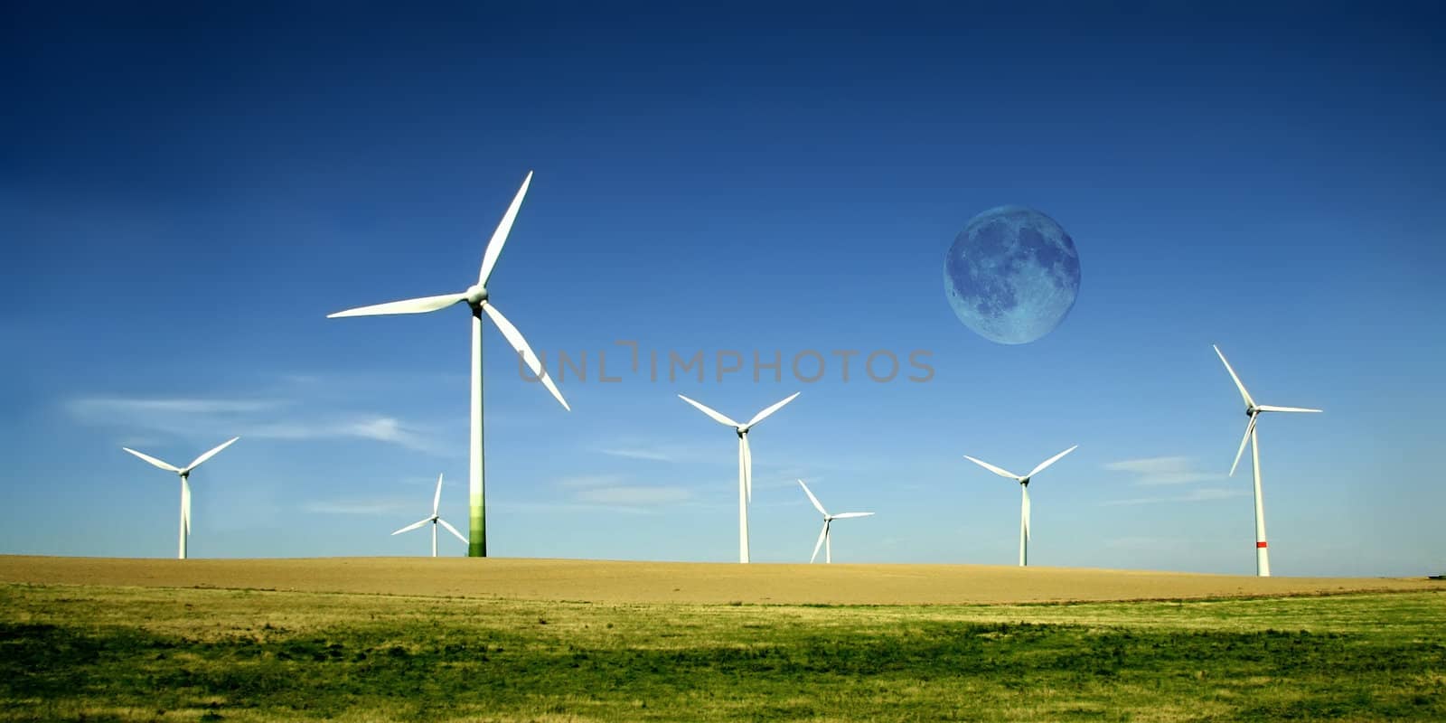 Wind turbines farm with full moon. Alternative energy source. 