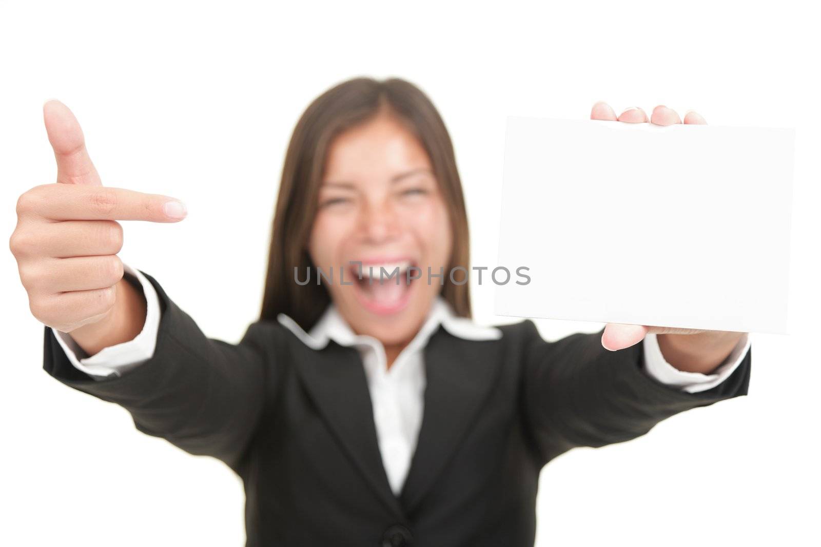 Business card. Excited woman pointing at business card / blank empty sign. Isolated on white background, focus on hand and card.