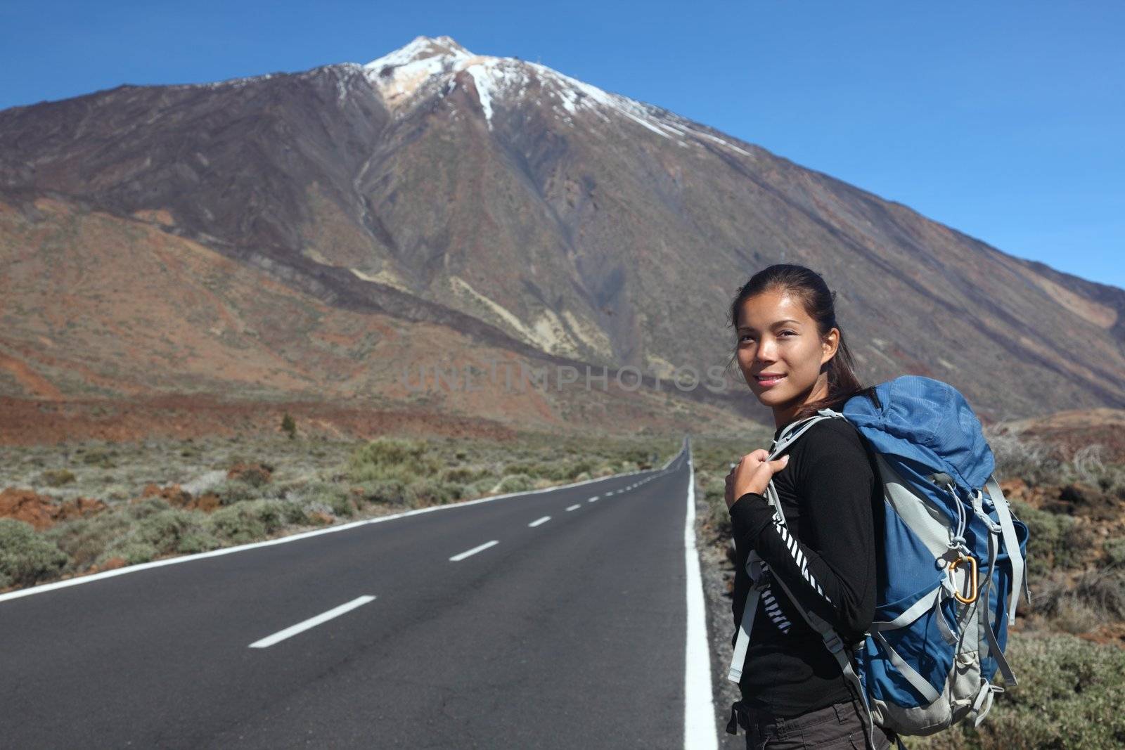 Traveler / hiker hitchhiking on road side. Teide, Tenerife.