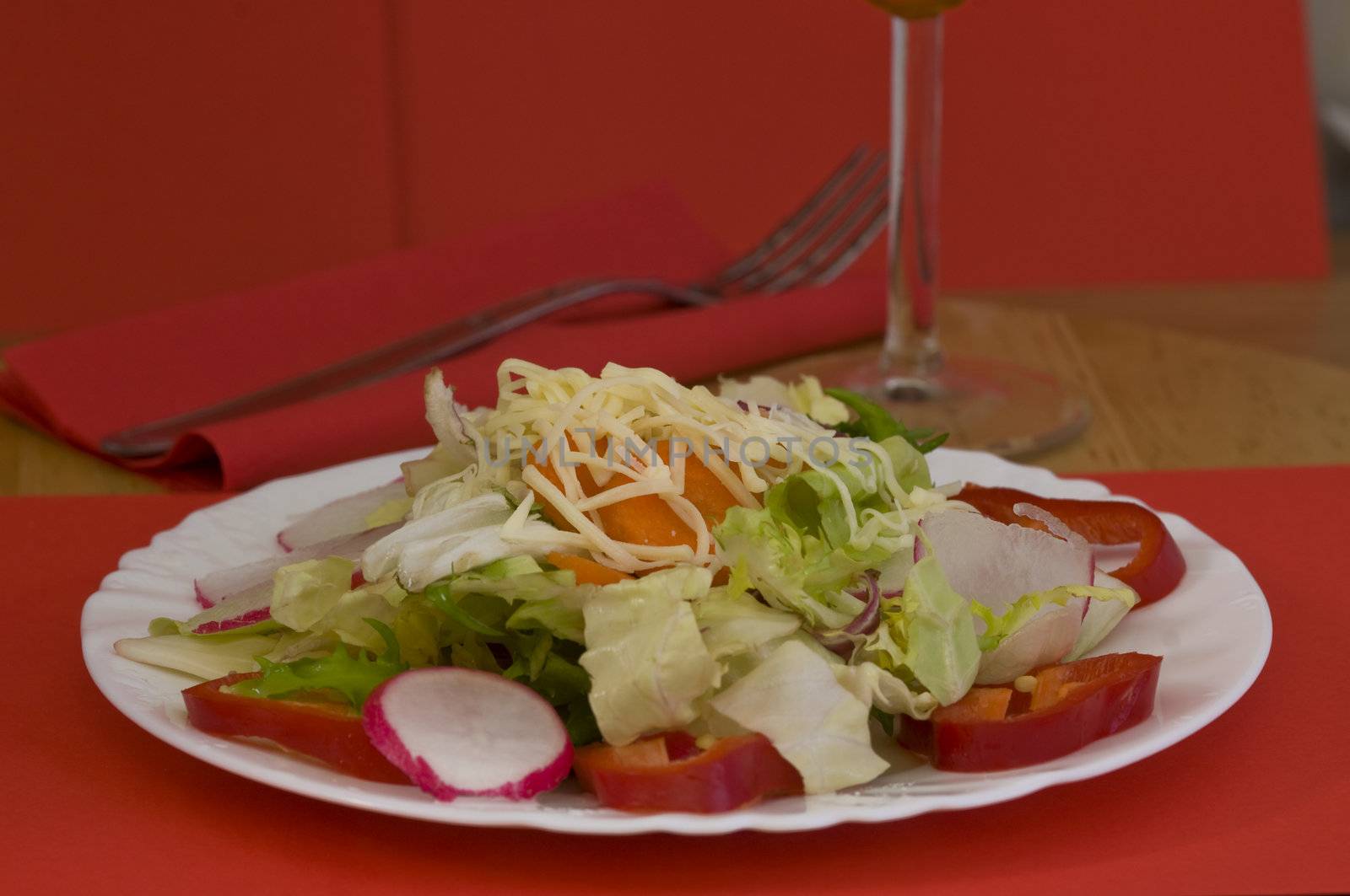 close-up on a light salad, on light wood background