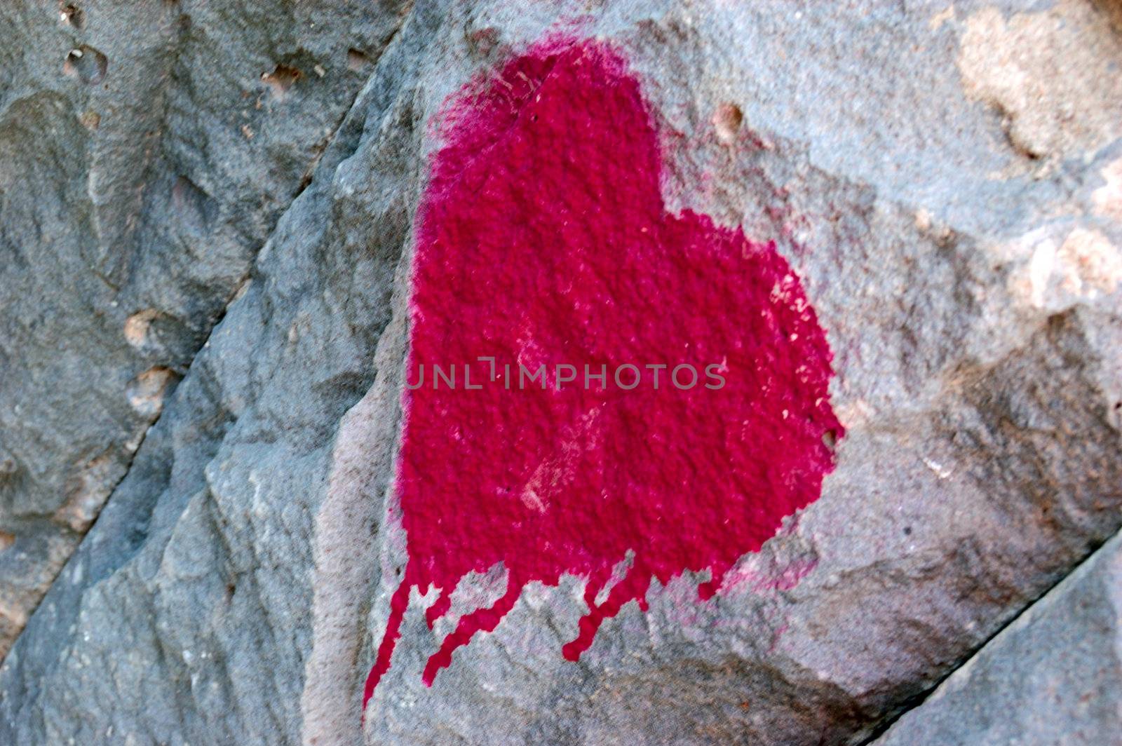 closeup of graffiti bleeding heart over grey wall