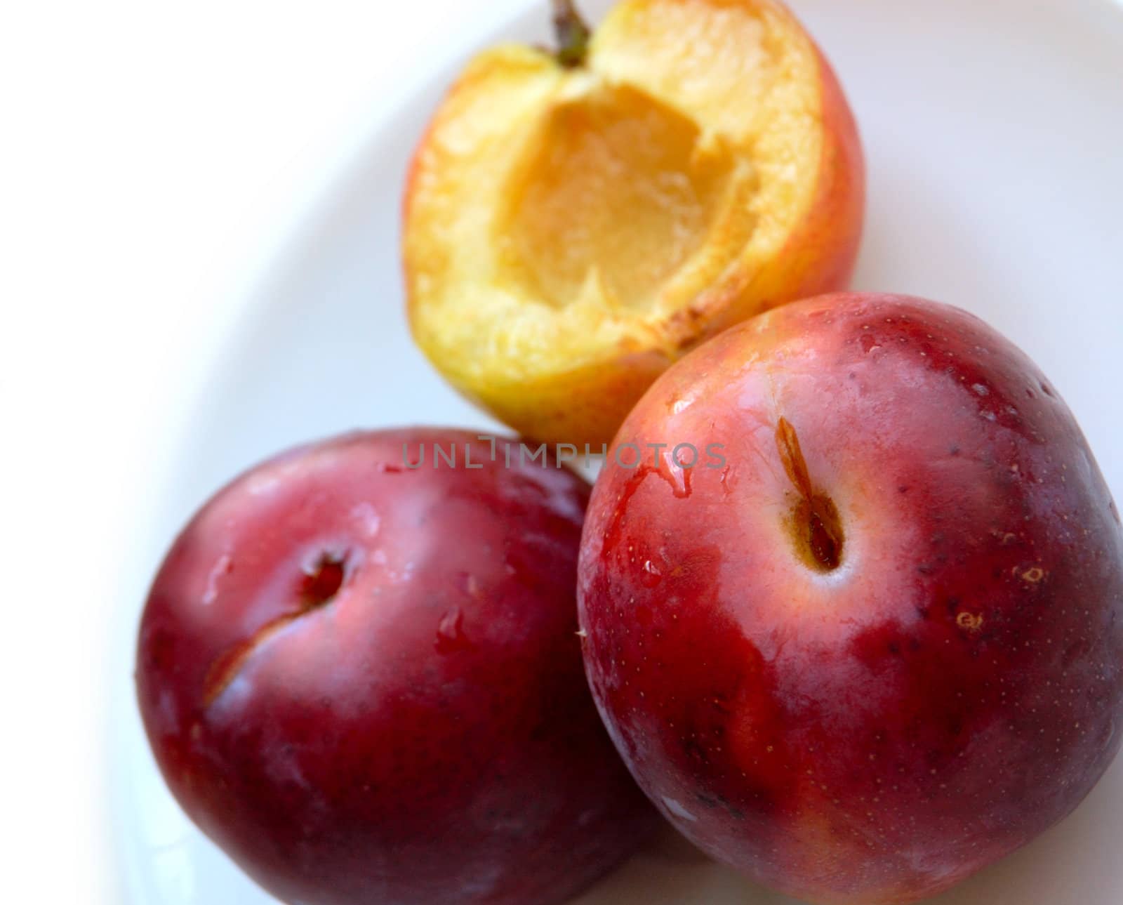 closeup of three ripe plums