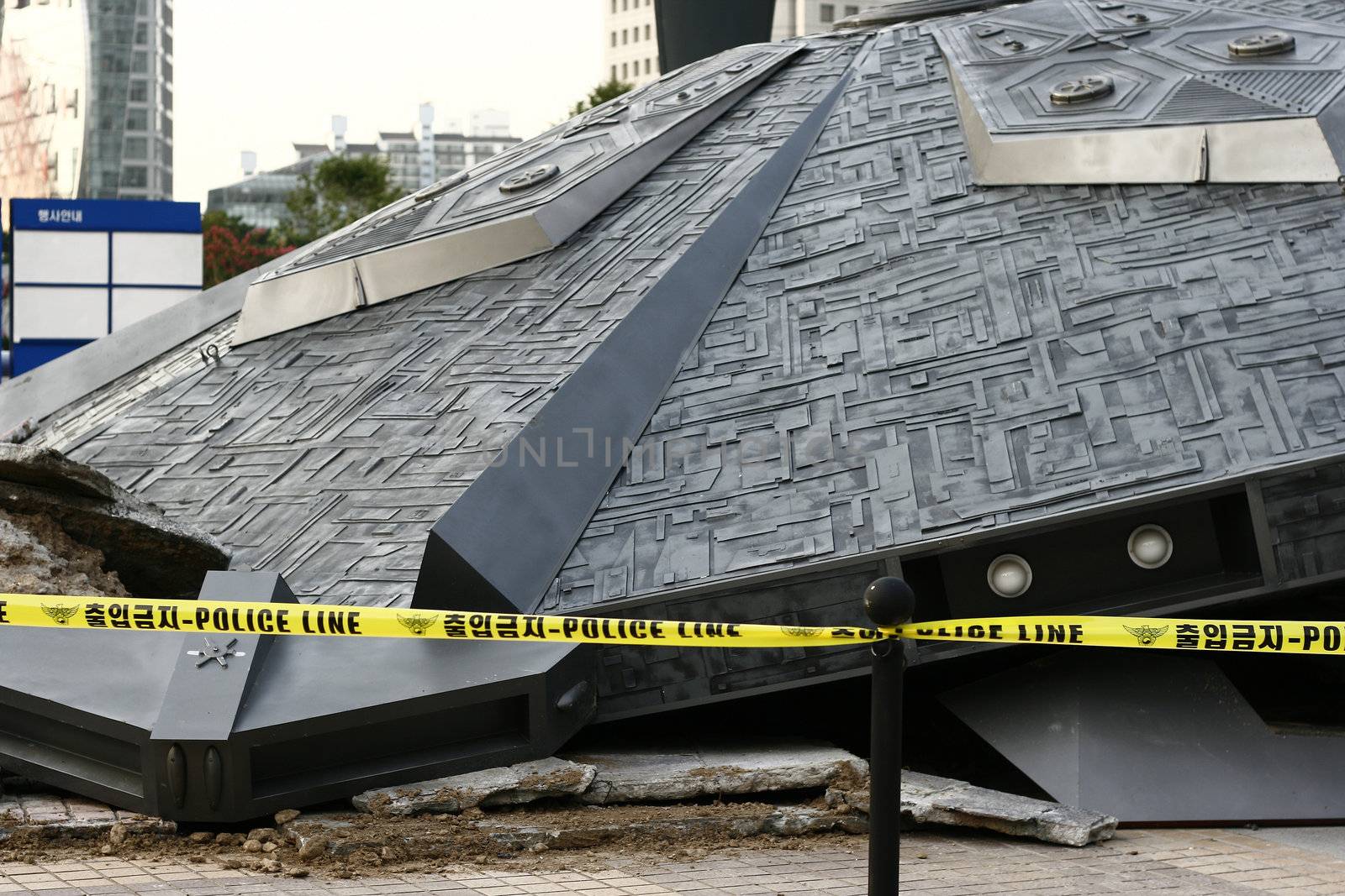 Modern art Crashed UFO at Seoul Korrea exhibit with police yellow line.