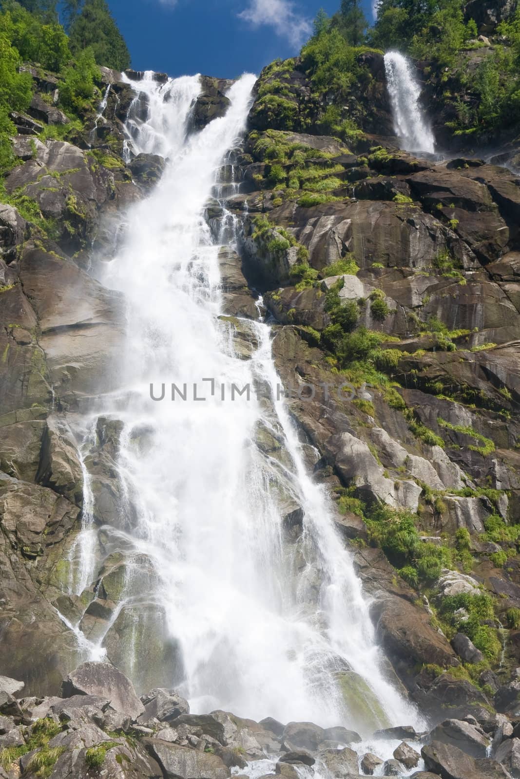 beautiful alpine waterfall in Val di Genova, Trentino, Italy