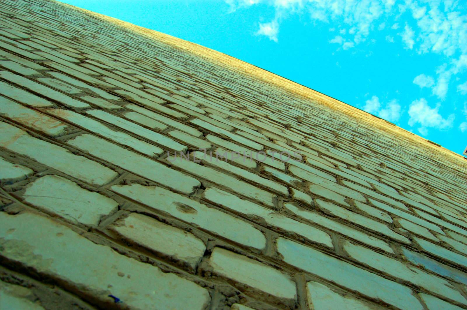 concencept of loneliness and depression - old-style wall of light bricks and sky