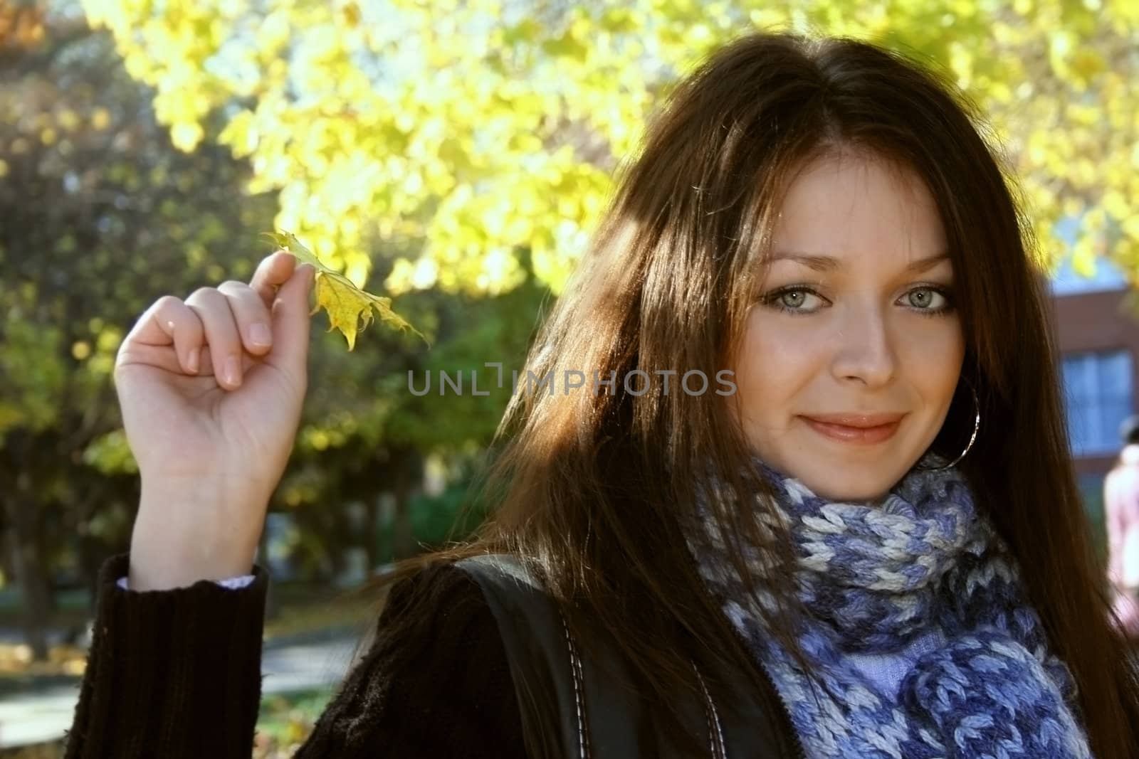 beautiful woman on autumn background with leaf 