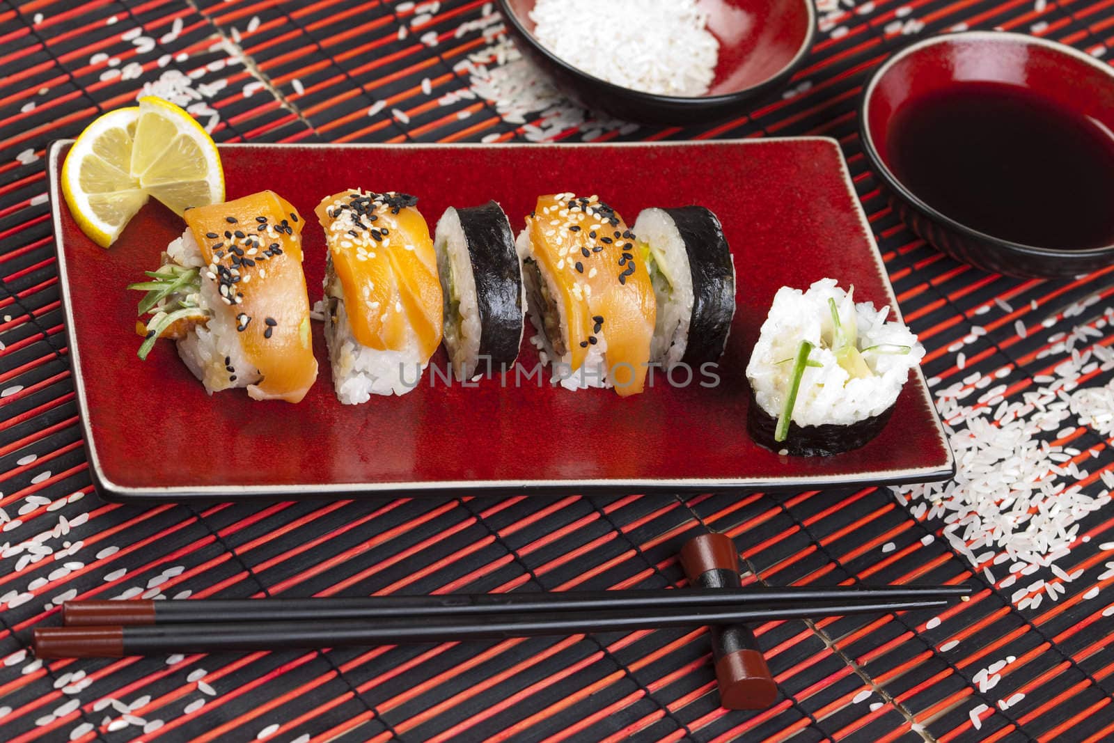 A complete sushi meal with chopsticks on tatami mat