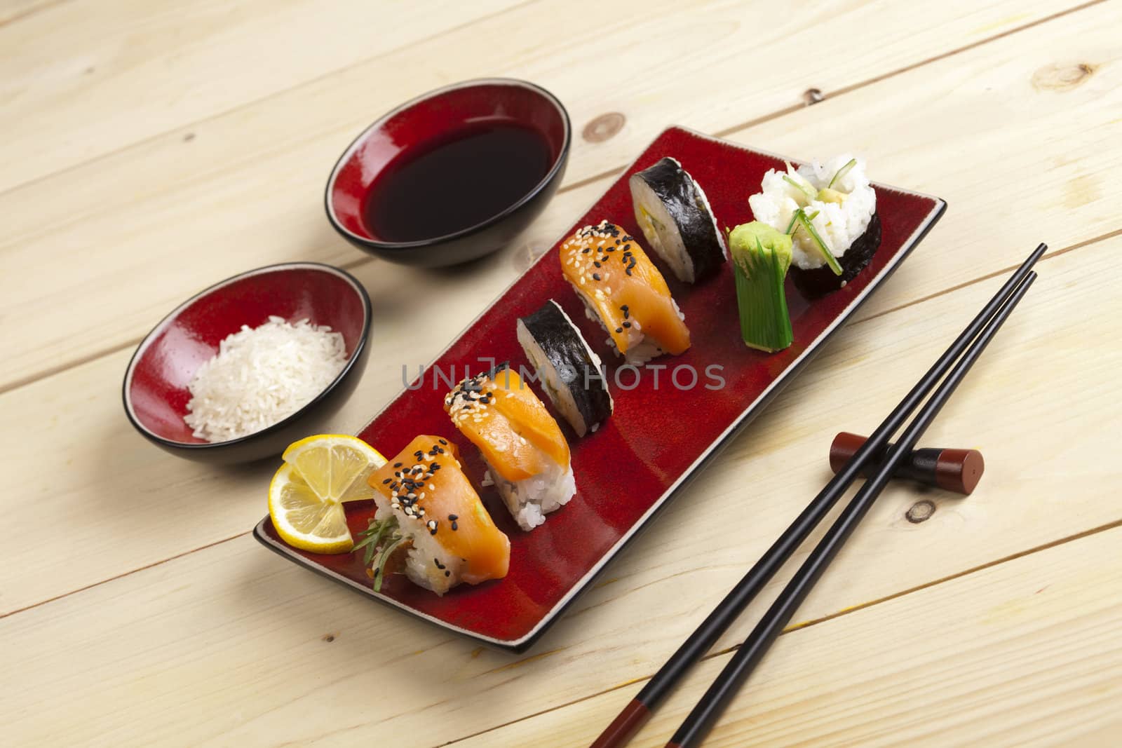 A complete sushi meal with chopsticks on tatami mat