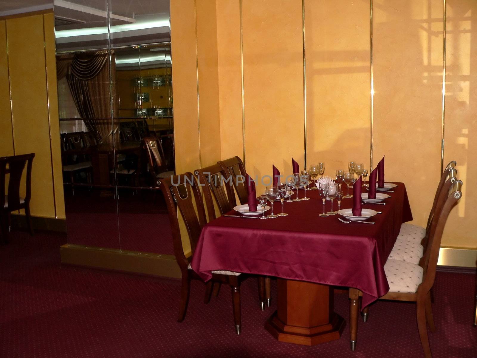 Table with crimson table cloth on restaurant
