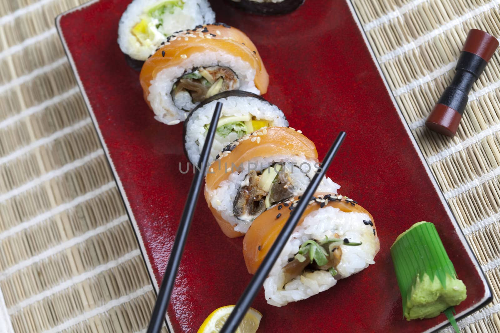 A complete sushi meal with chopsticks on tatami mat