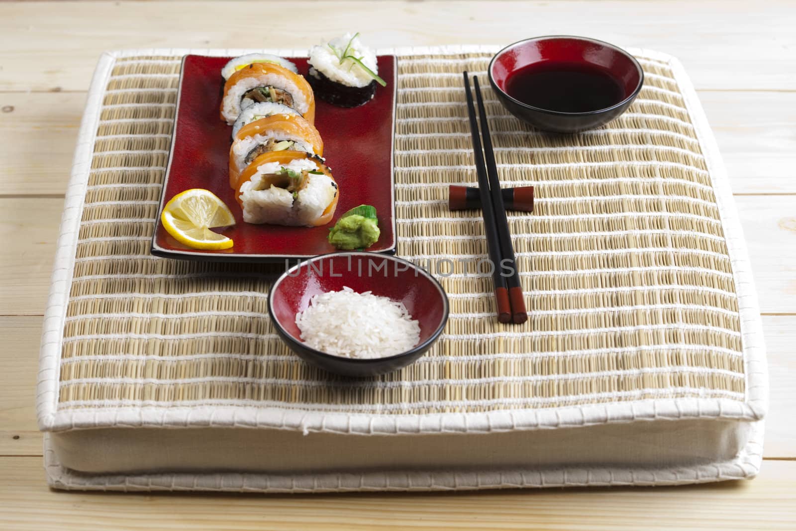 A complete sushi meal with chopsticks on tatami mat