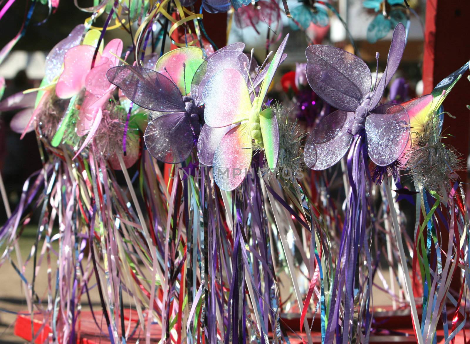 Butterfly wands for sale at a crafts booth. Very colorful and playful image.