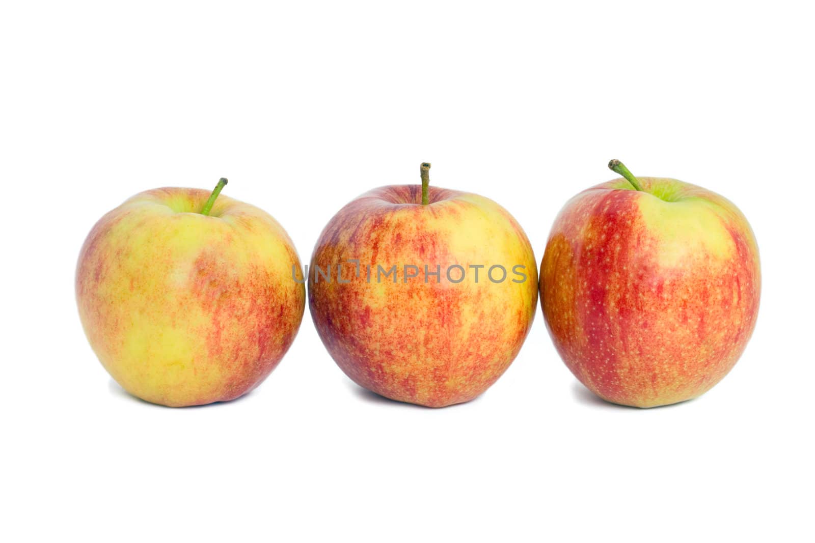 Three red apples, isolated on a white background.