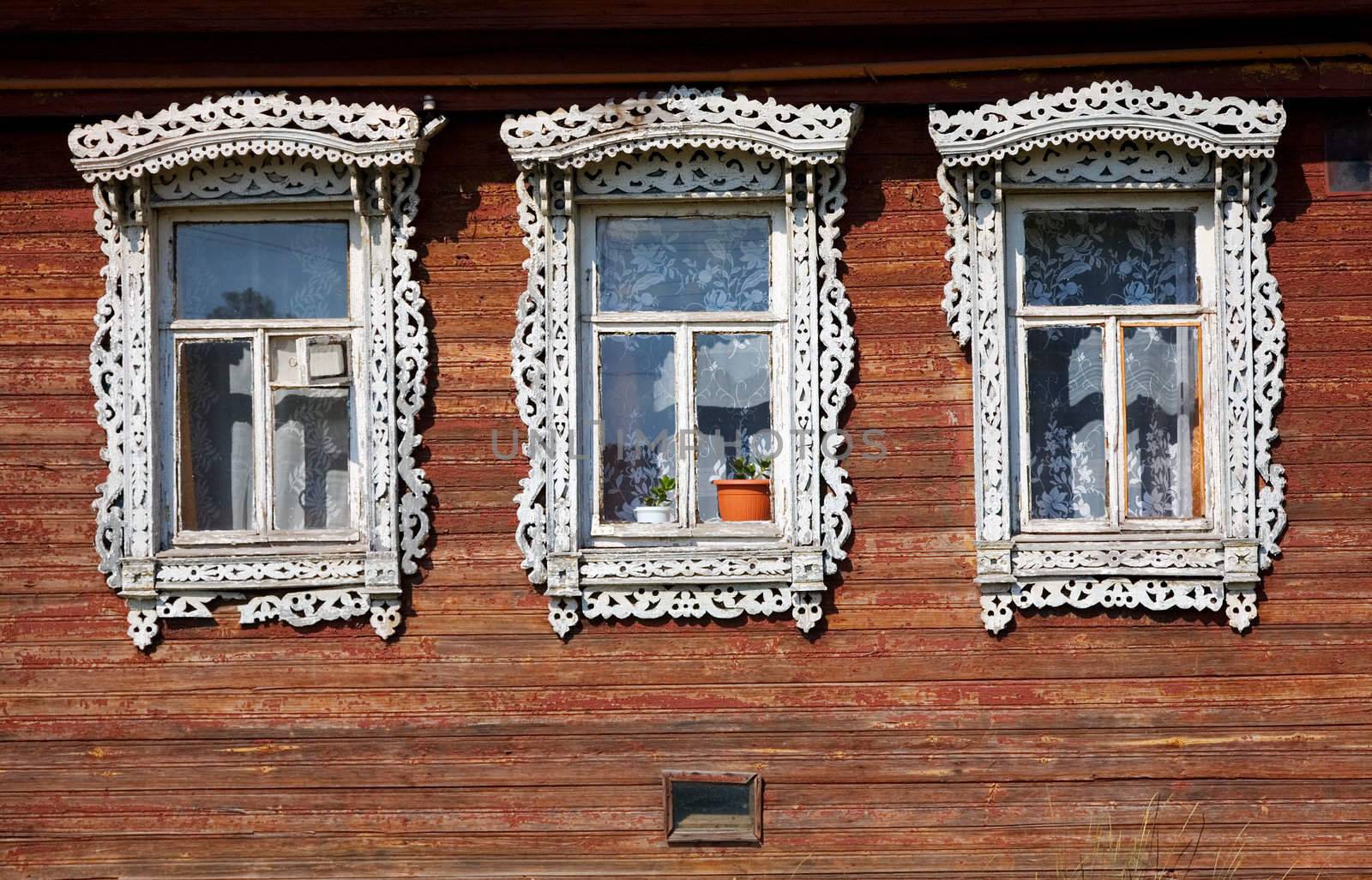 Three windows from old wooden rural wall