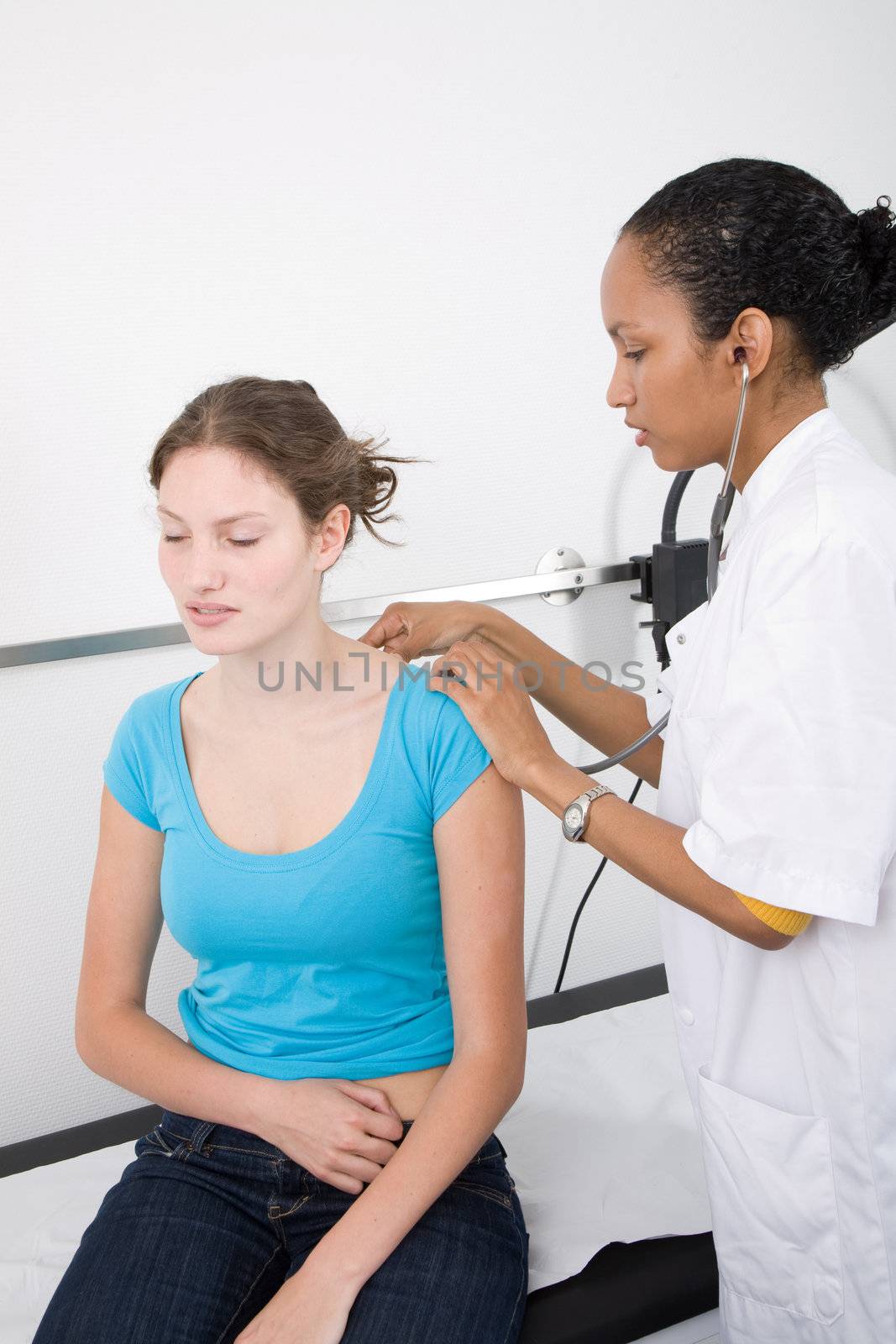 Doctor listening with the stethoscope to her patients breathing