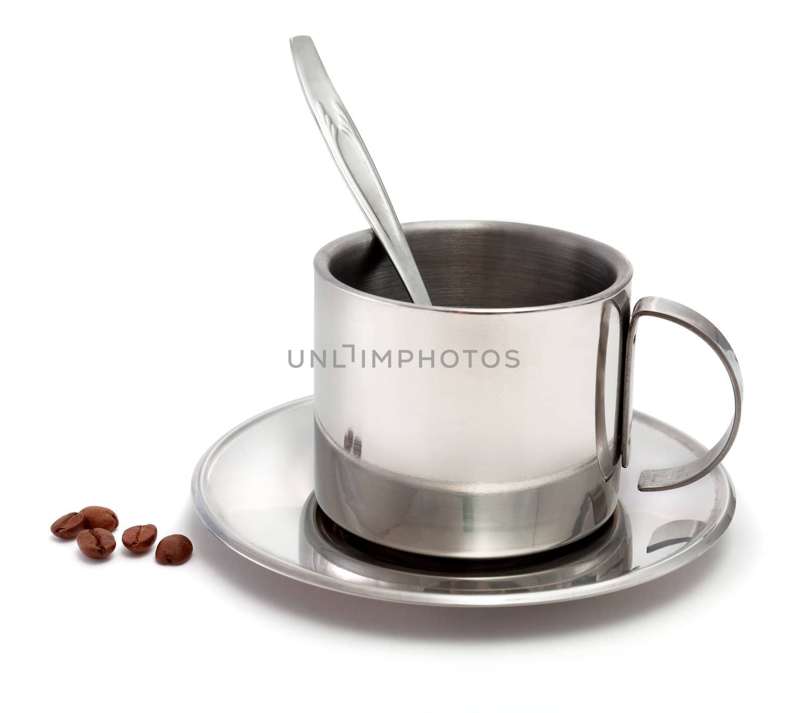 Metal coffee cup with a spoon and coffee grains on a white background
