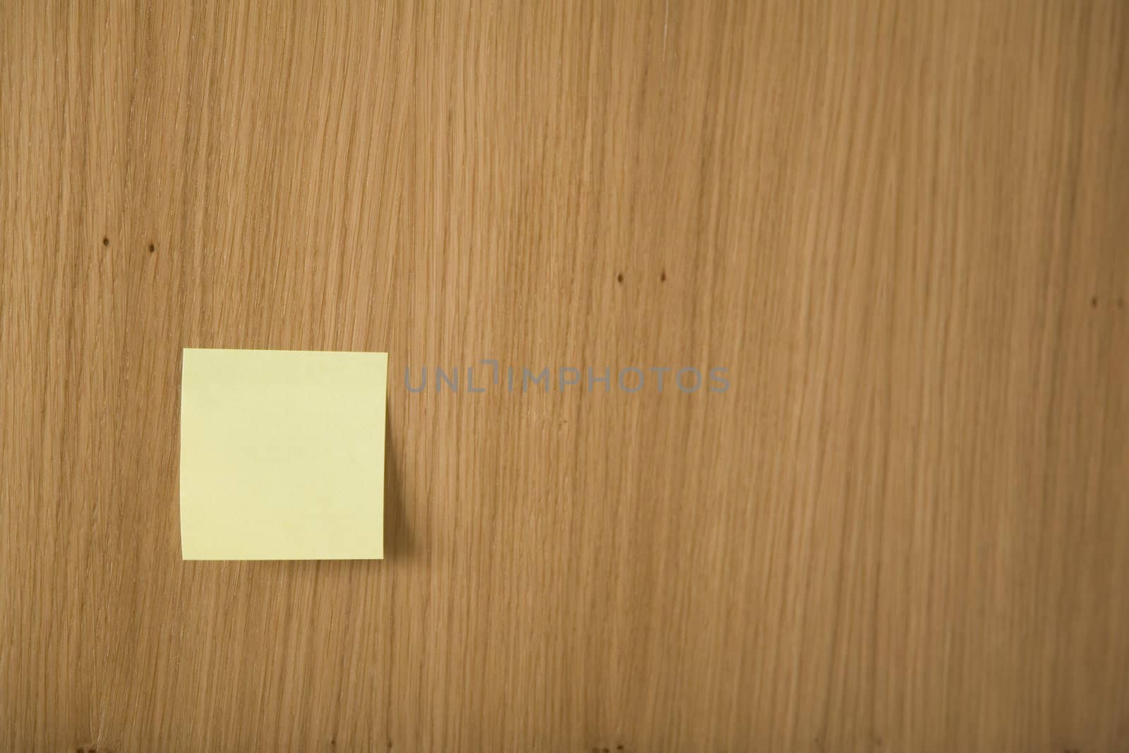yellow post it on wooden board