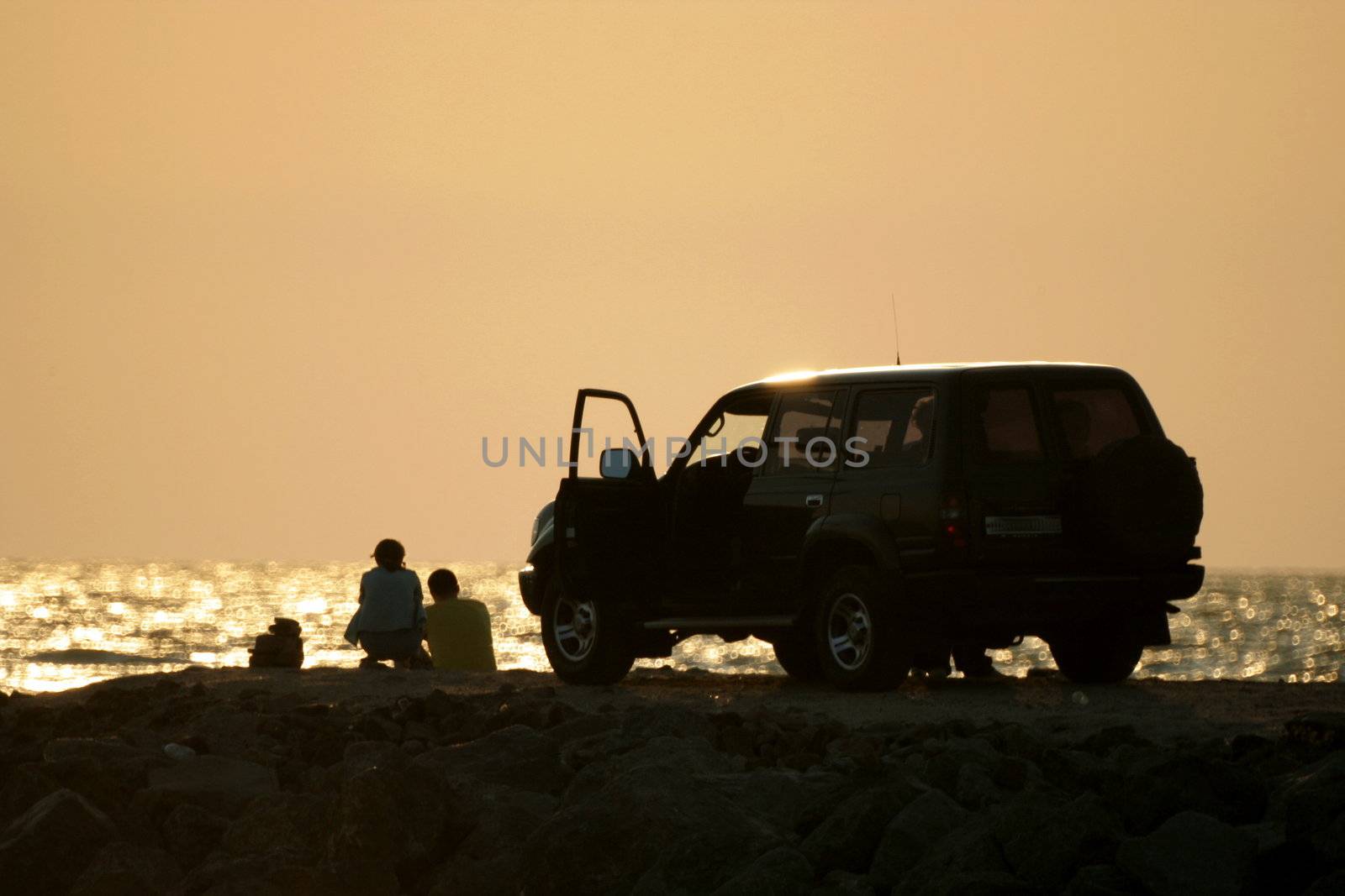 Young girl and fellow on sundown background 2