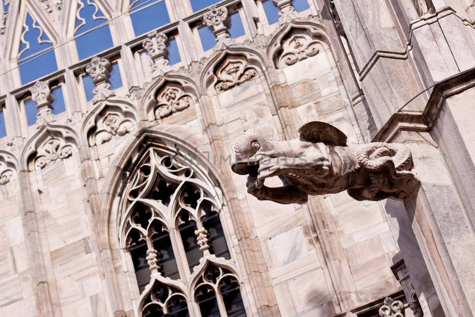 stone statue on the cupola of Milan's cathedral
