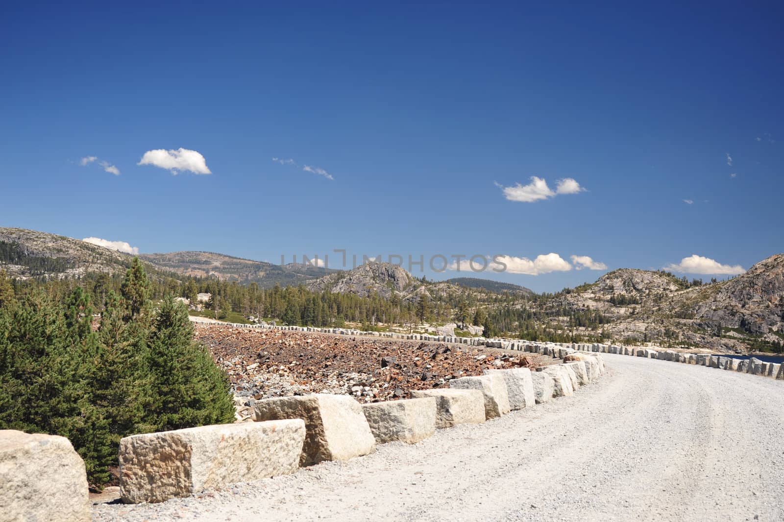 A bolder lined mountain road at the back of Loon Lake in the Crystal Basin area located in the El Dorado National Forest, USA.