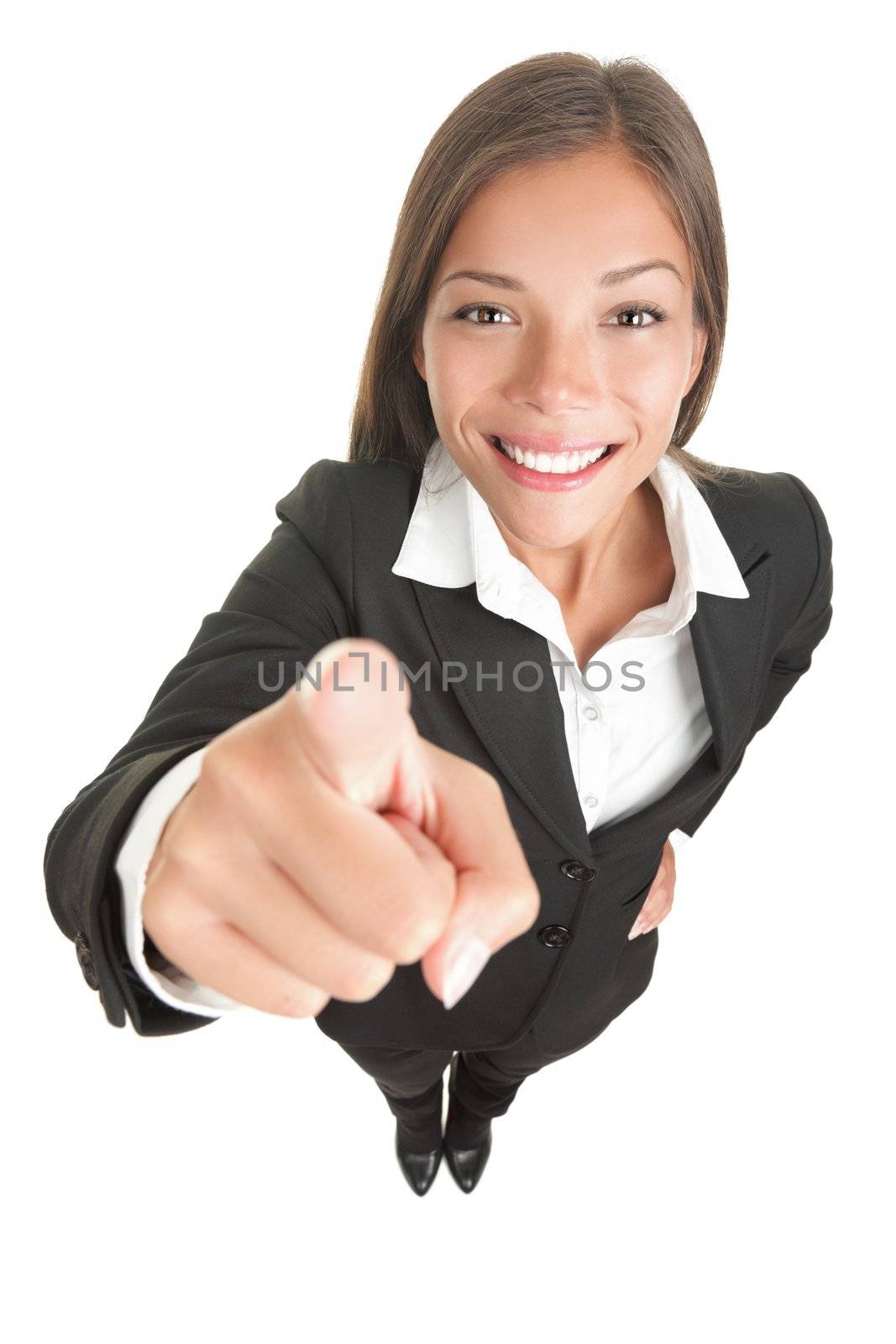 Woman pointing at camera that is above in high angle view. Wide angle, almost fish eye. Smiling mixed chinese asian / caucasian business woman. Isolated on white. 