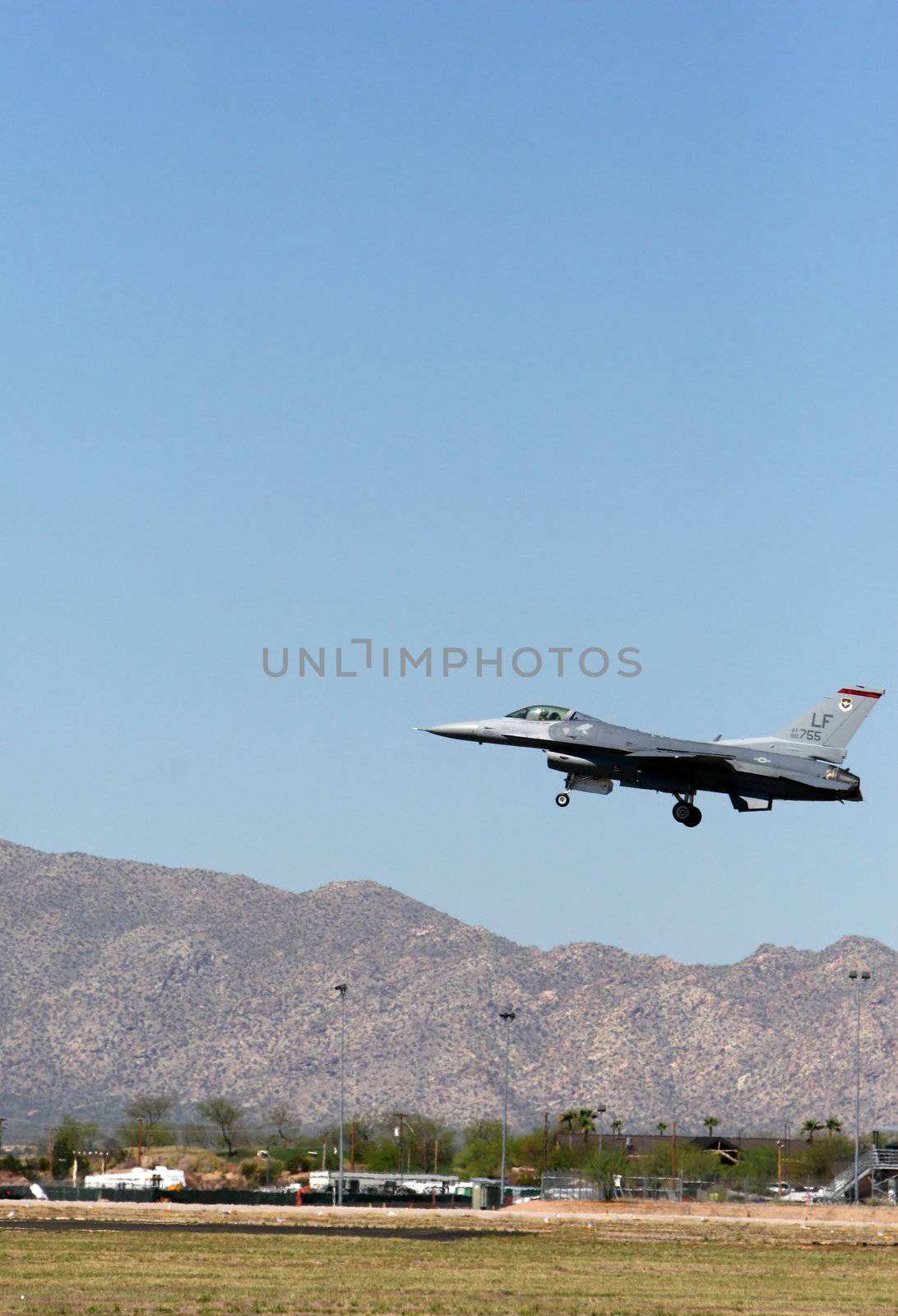 An airforce jet prepares to land on a desert runway