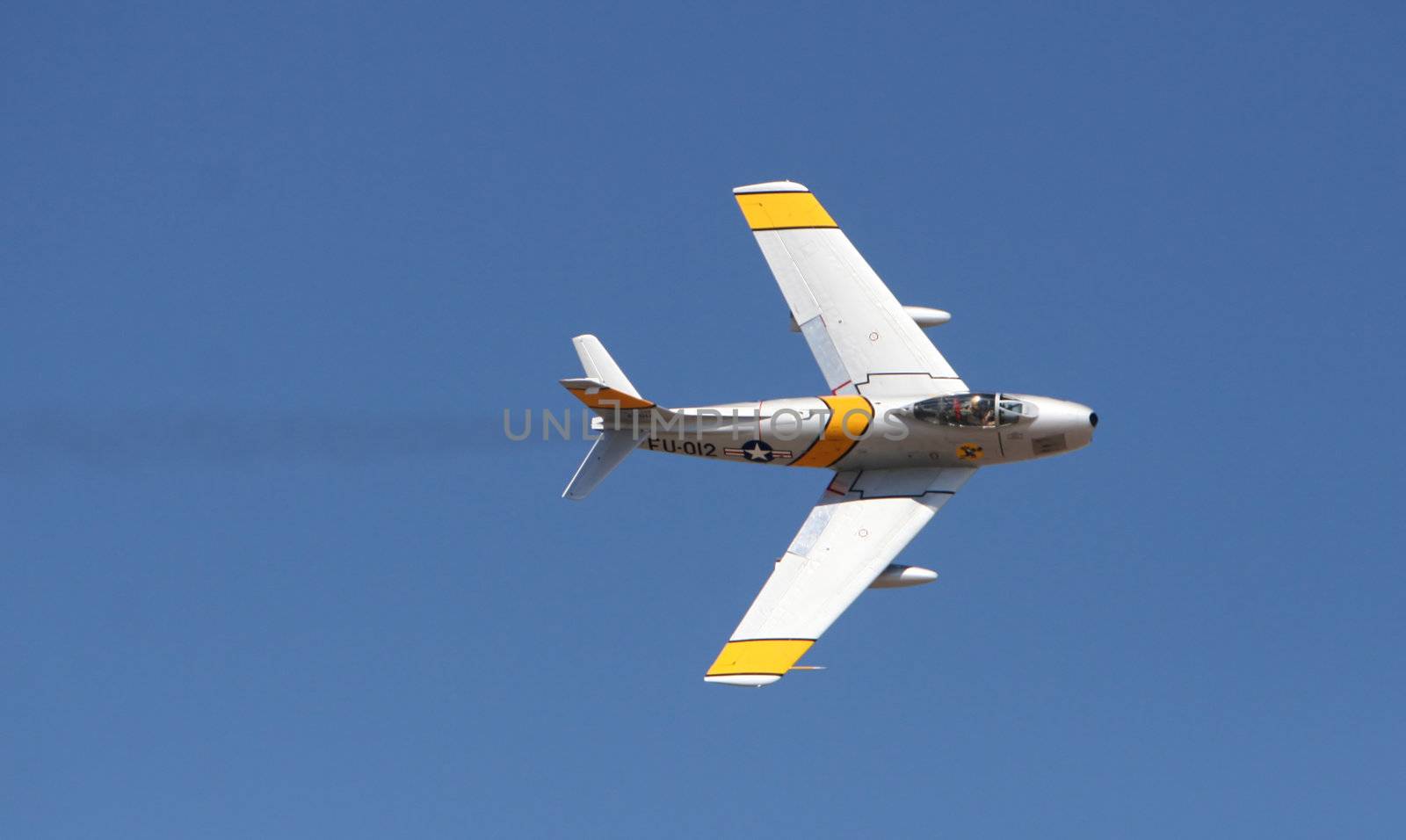 An air force jet executes a turn at an airshow