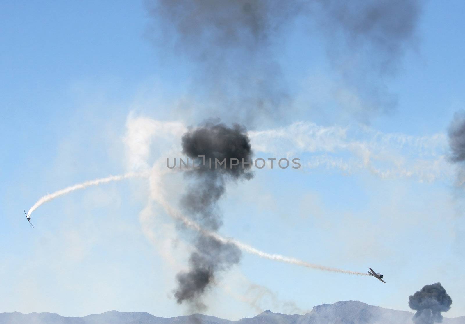 Old japanese warplanes fly through heavy smoke during a simulated attack on pearl harbor