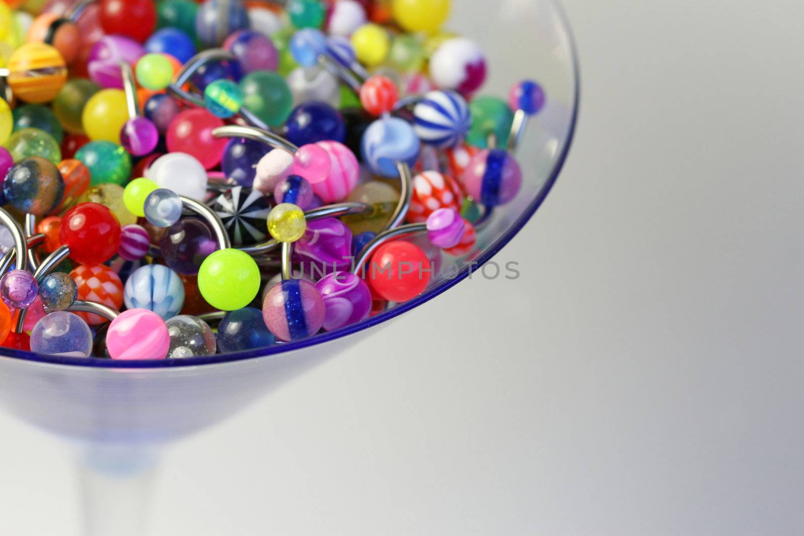 A martini glass full of navel rings